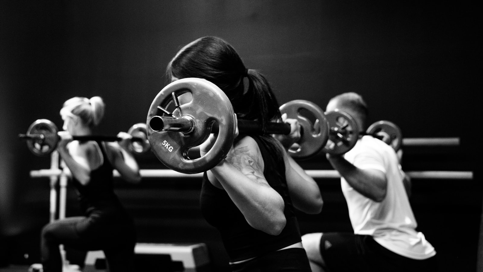 Group strength training session with barbells