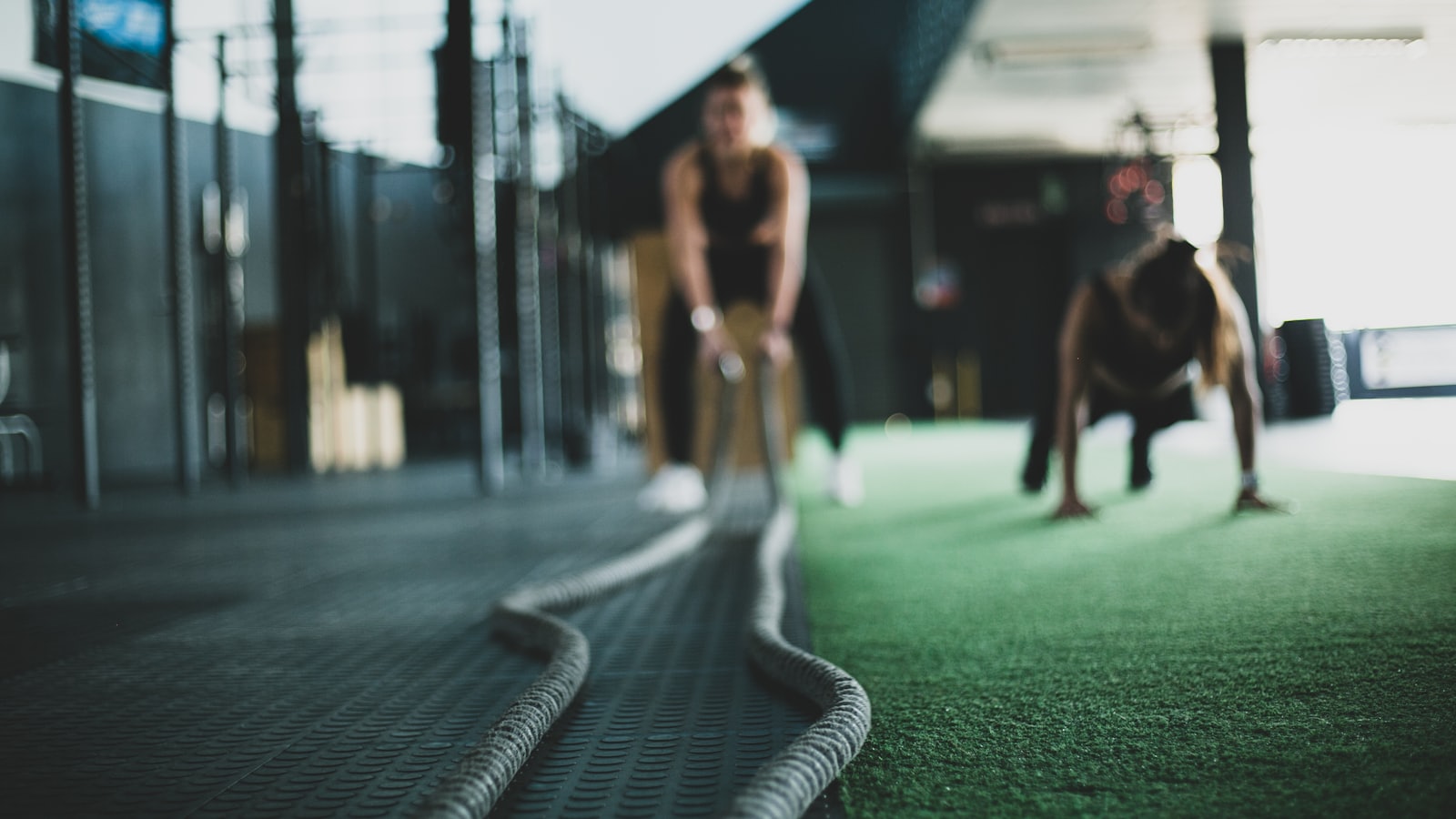 Two people training together in a gym